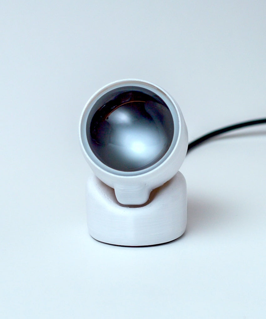 White camera lens on a light gray background